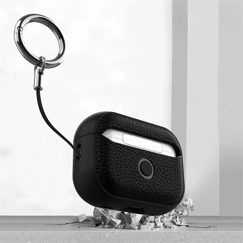 Black leather AirPods case with keyring and lanyard, top cutout visible
