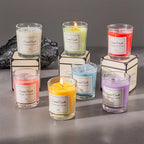 Aromatherapy candle gift box: six lit candles in glass jars (yellow, purple, orange, green)