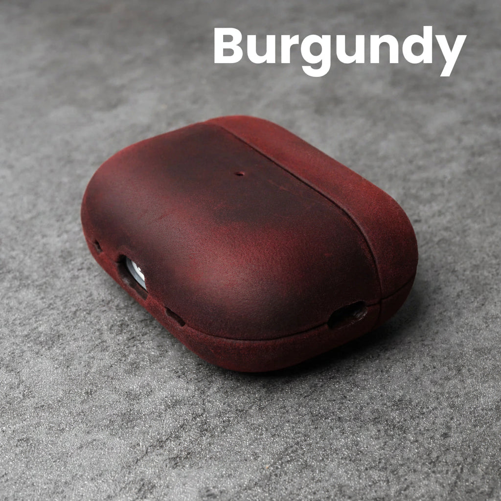Burgundy leather AirPods case with front cutouts and smooth rounded shell