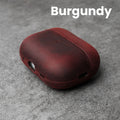 Burgundy leather AirPods case with front cutouts and smooth rounded shell