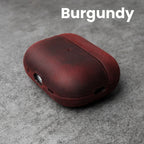 Burgundy leather AirPods case with front cutouts and smooth rounded shell