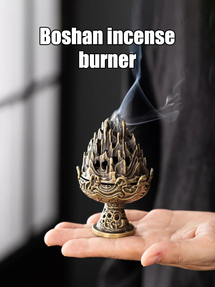 Boshan copper incense censer held in hand, ornate flame-top design with smoke