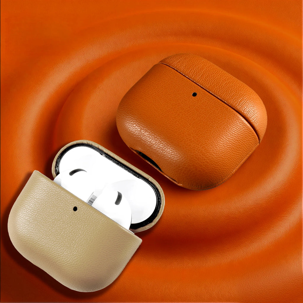 Close-up of warm brown eco leather AirPods case with earbuds inside, textured grain surface