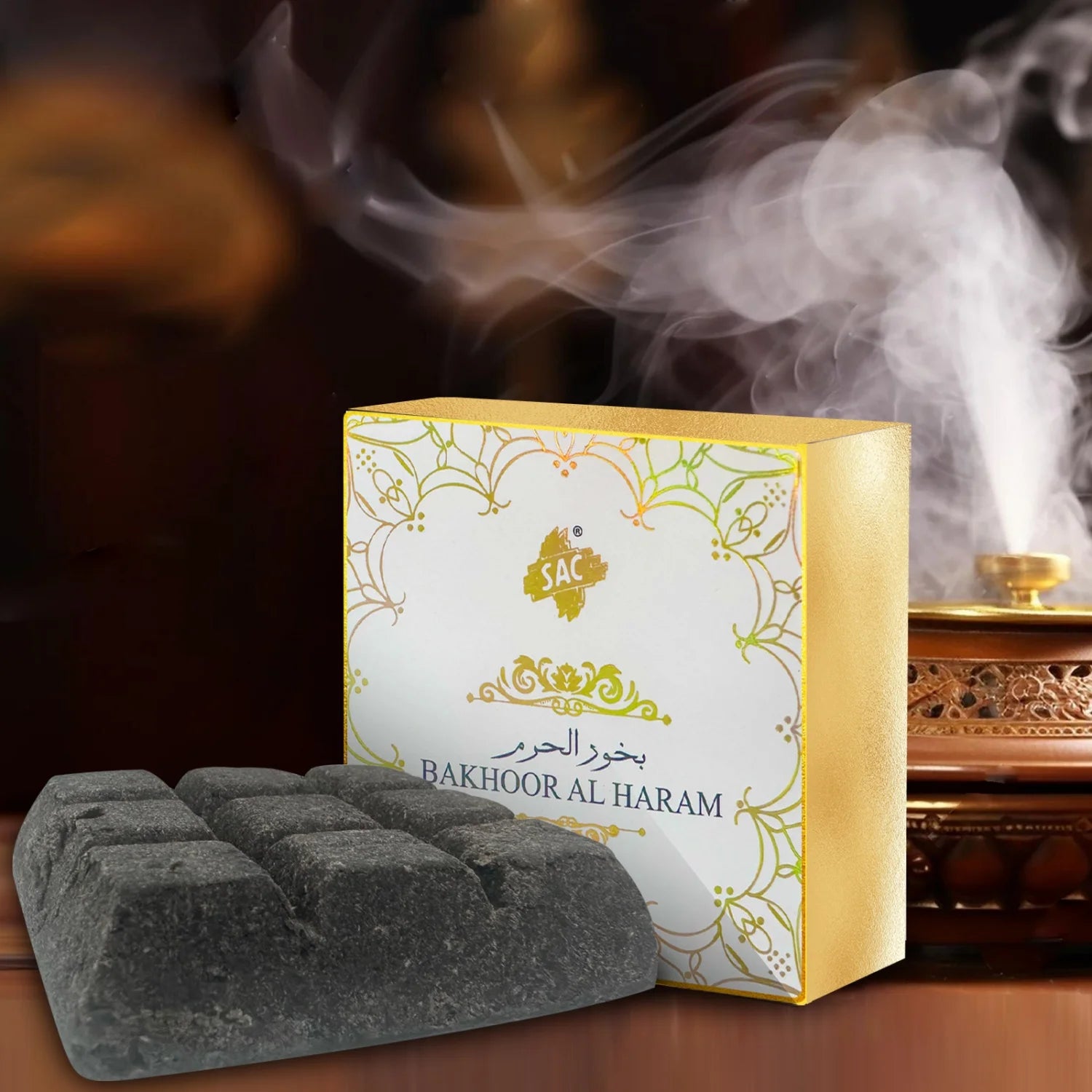 Bakhoor fragrance box with smoke and dark gray incense bricks on tray