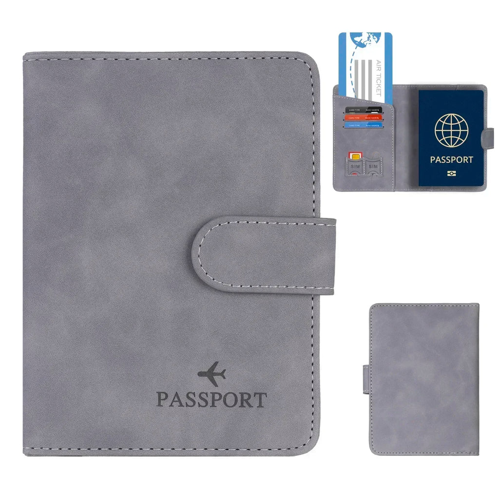 Slate grey RFID passport wallet with fold-over strap and stitched oval tab detail