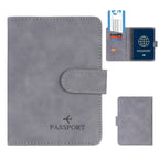Slate grey RFID passport wallet with fold-over strap and stitched oval tab detail