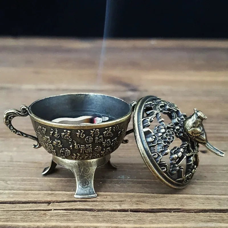 Copper lotus incense burner base with engraved text and lifted lid revealing inner holder