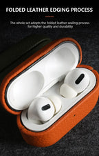 Amber Glow leather AirPods case, open with earbuds inside and hinged lid on top