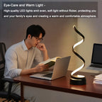 Spiral dimmable LED bedside lamp glowing warm white in a zigzag curve; black base