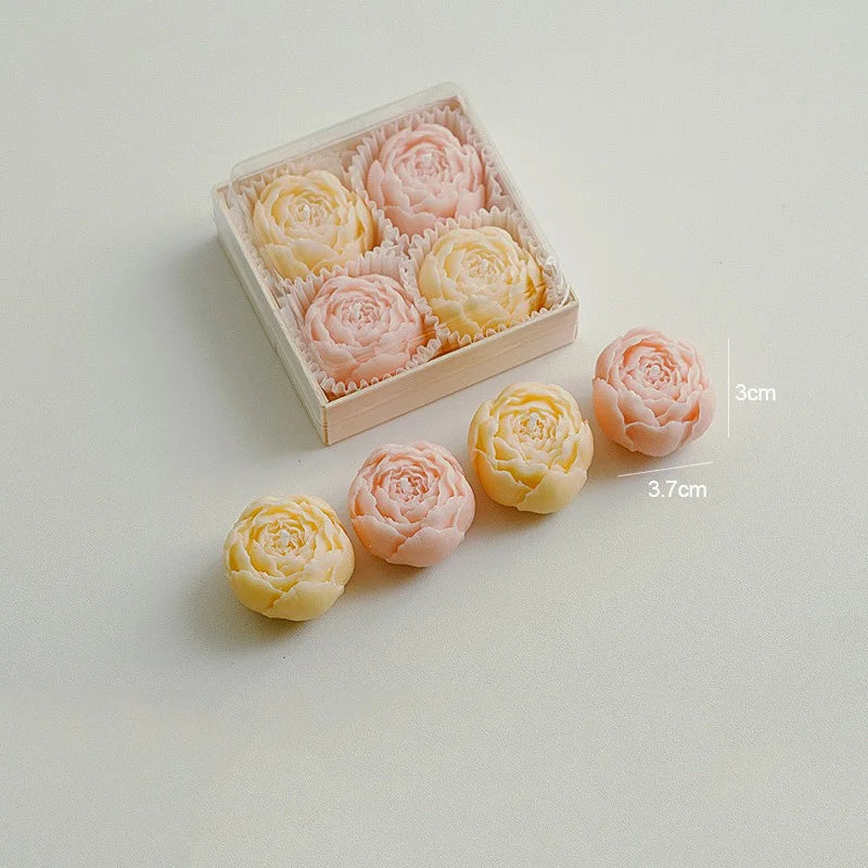 Ivory and peach rose-shaped scented candles in a gift box with loose candles