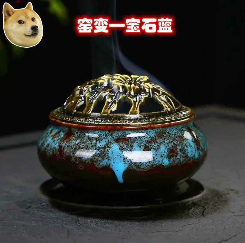 Blue speckled ceramic incense burner with ornate gold lid and smoke