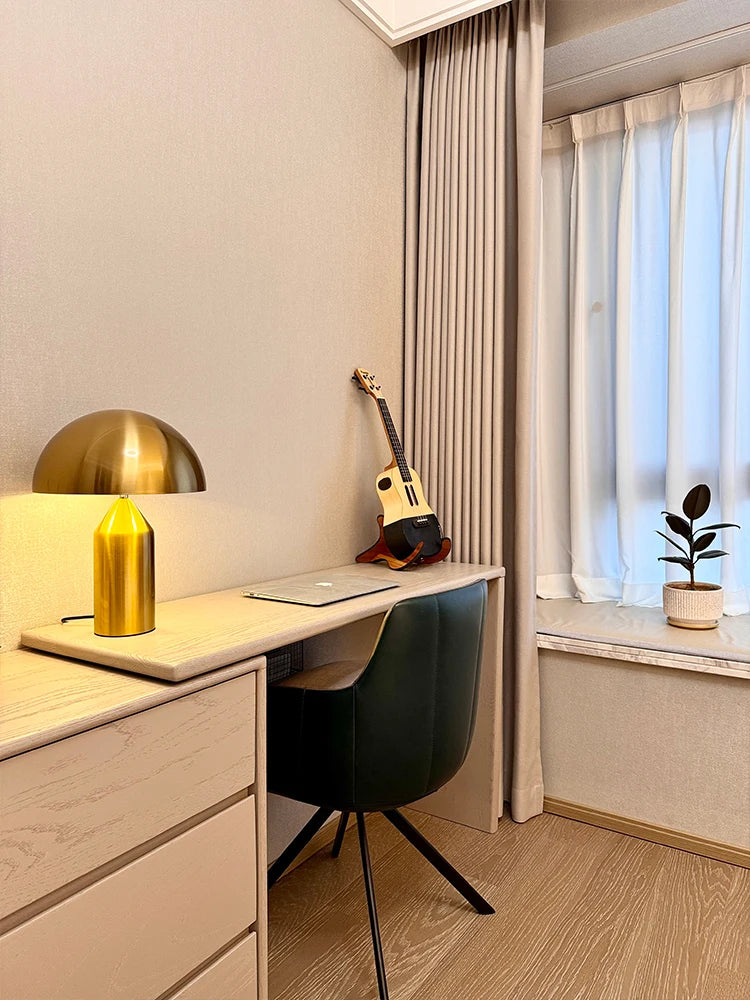 Gold mushroom LED table lamp with rounded dome shade and column base, warm glow