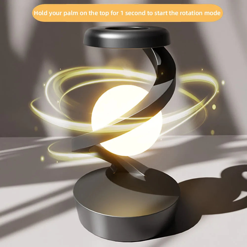 Rotating wireless charging RGB lamp with bright white orb and swirling gold light rings