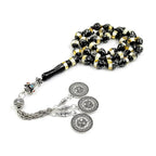 Black and gold prayer beads tasbih with silver medallion charms and small blue bead detail