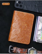 Cognac brown leather travel folio with raised floral embossing and stitched edge