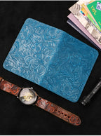 Midnight Blue embossed leather travel folio shown closed with watch and cards