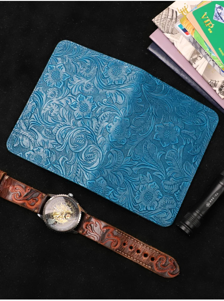 Midnight Blue embossed leather travel folio shown closed with watch and cards