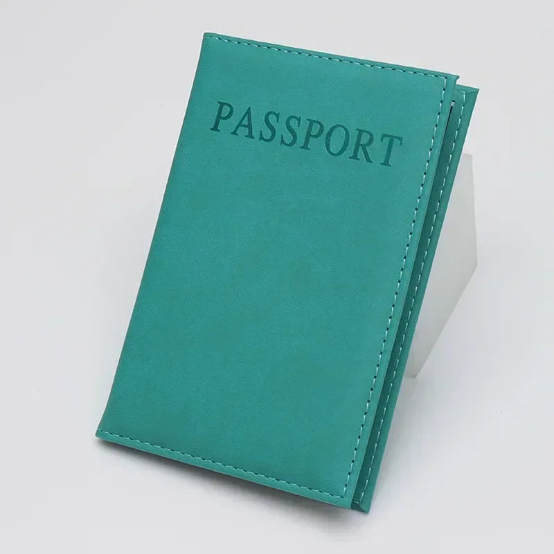 Turquoise passport sleeve with embossed “PASSPORT” and double stitched border