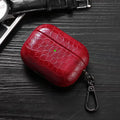 Ruby red crocodile-grain AirPods case with keychain carabiner clip.