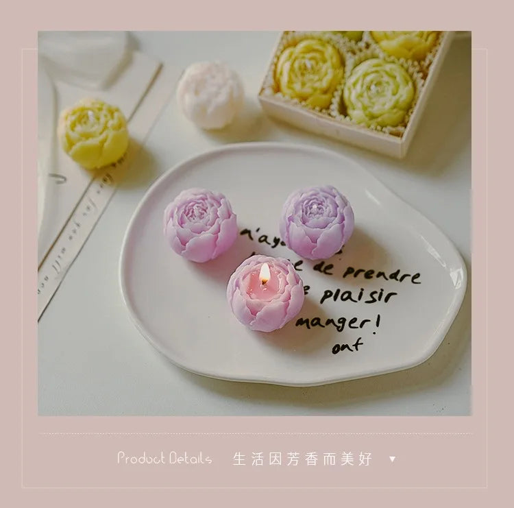 Lilac rose-shaped scented candles on a plate, with a matching candle gift box