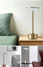 Gold cordless reading lamp with round top and cylindrical base on a tabletop