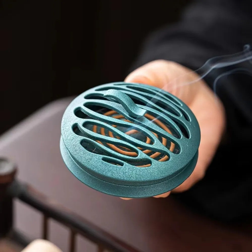 Blue round incense burner with oval hollow cutouts and smoke stream