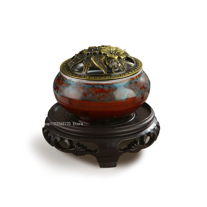 Ceramic electric incense warmer, ornate gold lid on a black pedestal base