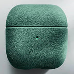 Italian suede AirPods case in Emerald Sage, smooth suede texture, closed