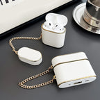 White wrist strap AirPods case with chain; AirPods earbuds in the case.