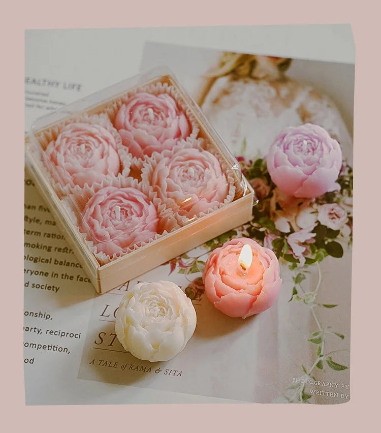 Peach rose-shaped scented candle gift box with several candles and a loose candle