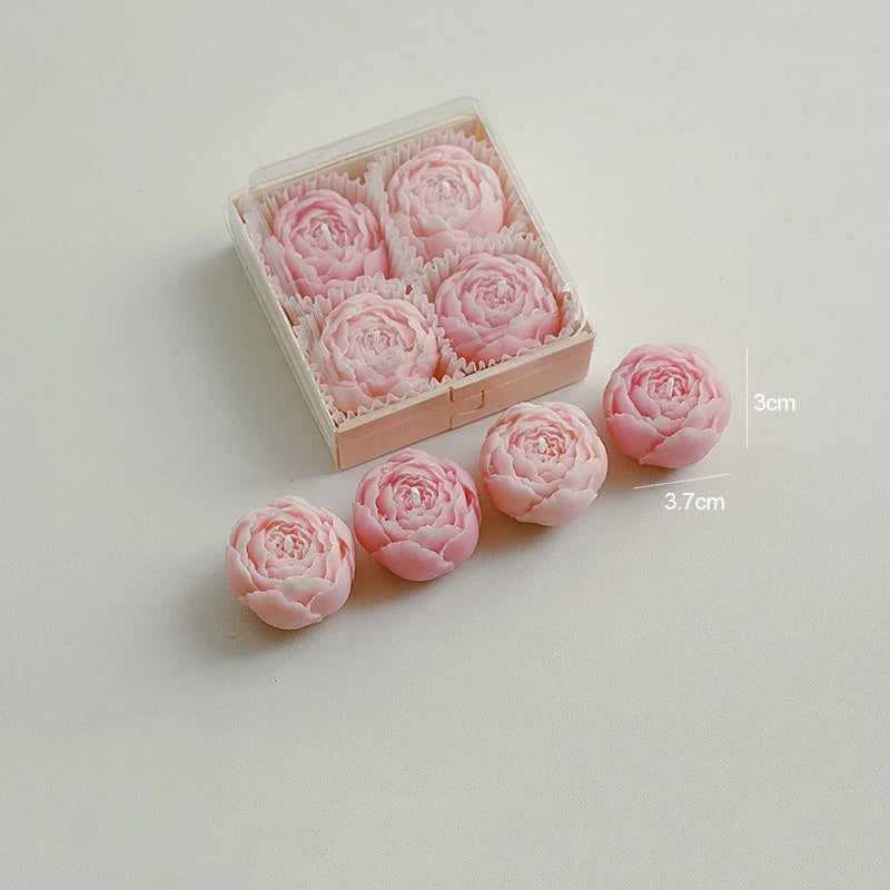 Blush pink rose-shaped scented candles in a gift box with loose rose candles