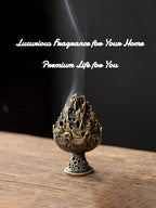 Copper-toned incense burner with flame-lotus top on a base, emitting a vertical plume.