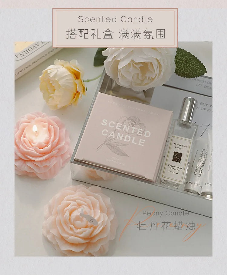 Peach peony sculptural candle beside scented candle box and sprayer