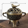 Antique-brass incense burner with bird finial, engraved bowl and legs
