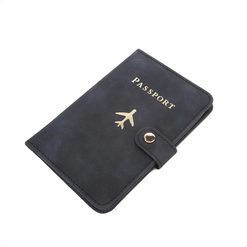 Midnight black passport cover with airplane emblem, “PASSPORT” lettering, and snap tab