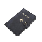 Midnight black passport cover with airplane emblem, “PASSPORT” lettering, and snap tab