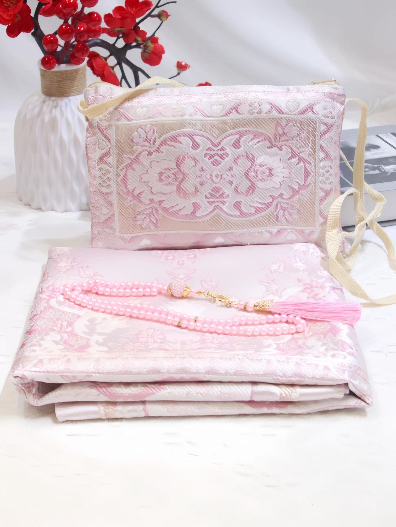 Prayer rug gift set with pink embroidered pouch, folded pink mat, and pink beaded tassel