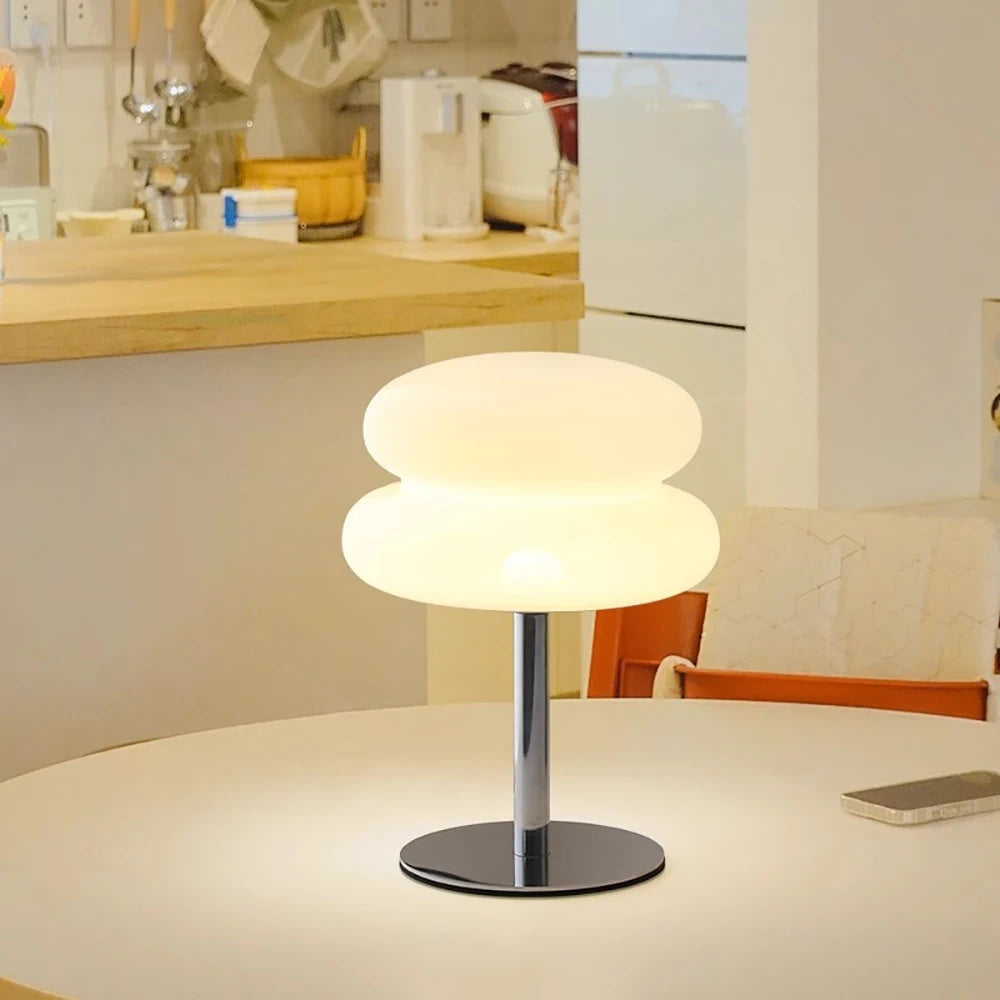 Mushroom USB ambient table lamp glowing warm white on a countertop with round metal base.