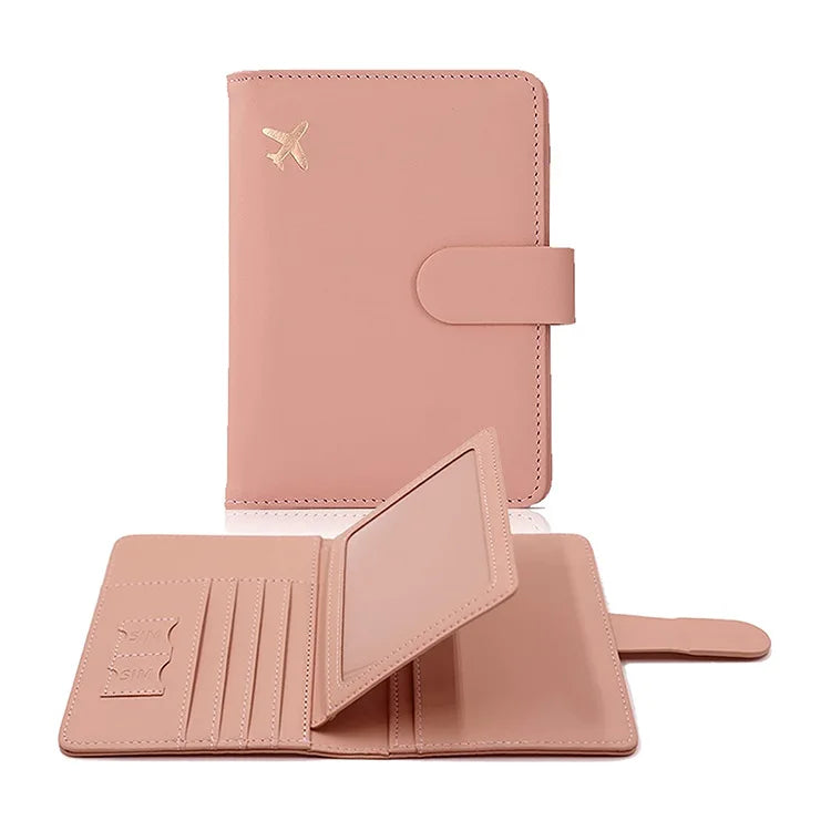 Blush pink passport cover with airplane emblem and flap closure; open card holder shown