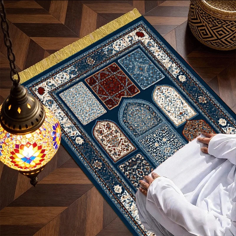 Islamic-style prayer mat with blue border, patterned panels, and gold fringe edge