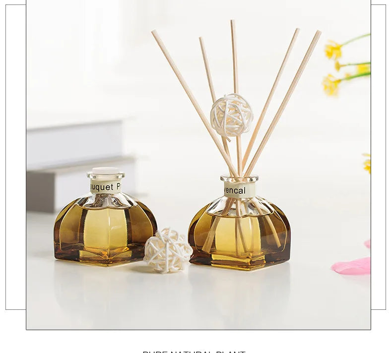 Reed diffuser set of two amber bottles with light reeds and white woven balls