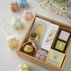 Gift box set with sculptural bubble candles in assorted pastel colors, plus a small jar