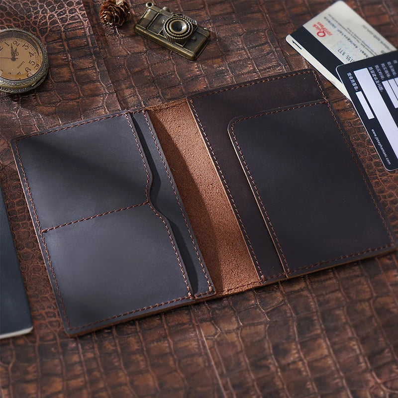 Vintage cowhide passport wallet with two card slots and central divider, dark brown finish
