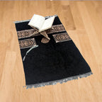 Dark prayer rug with open-book and decorative border, with scalloped fringe edges