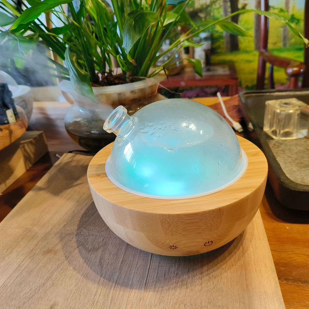 Luxe aroma diffuser with glass dome on Natural Wood base, blue glow and clear lid