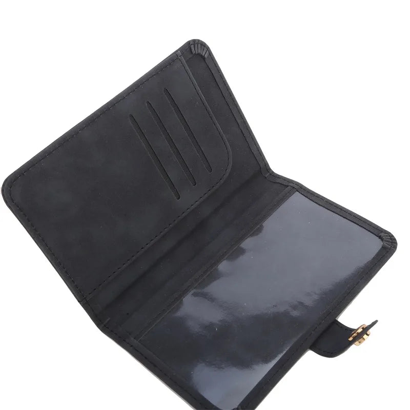 Interior view of dark passport cover with card slots and elastic pocket, stitched finish