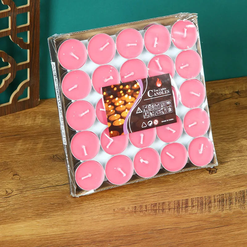 Pink tea light candles in a box tray, each with a white wick tip