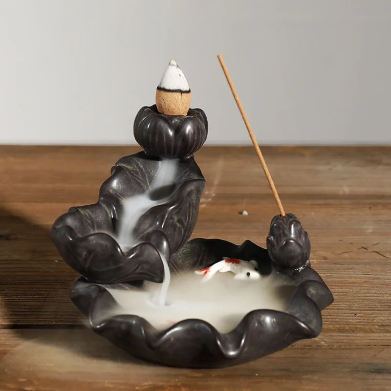 Backflow incense burner with seated hand shape, wood incense stick and smoke pool