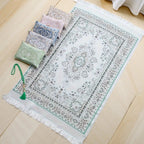 Prayer rug gift set with green patterned prayer mat, tassels, and small storage pouches