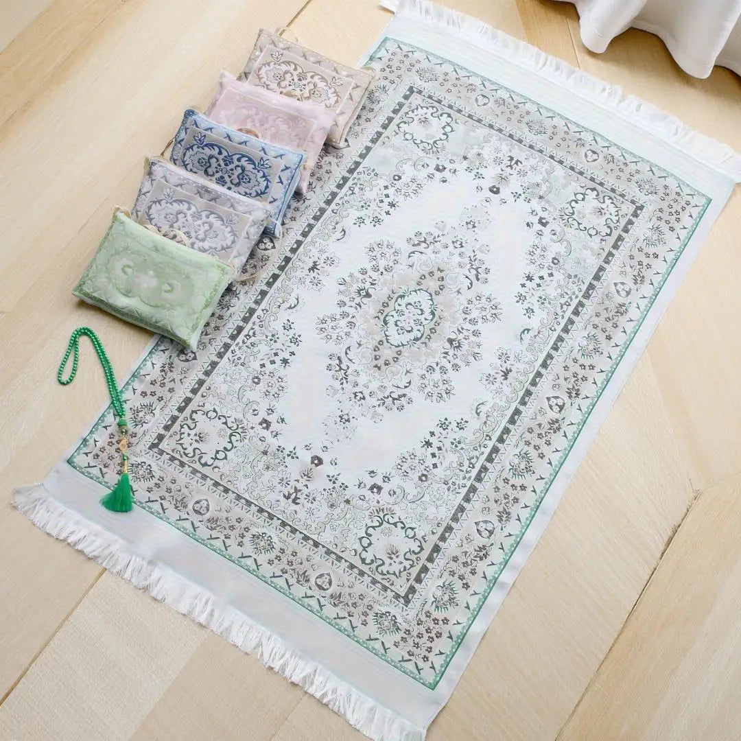 Prayer rug gift set with green patterned prayer mat, tassels, and small storage pouches